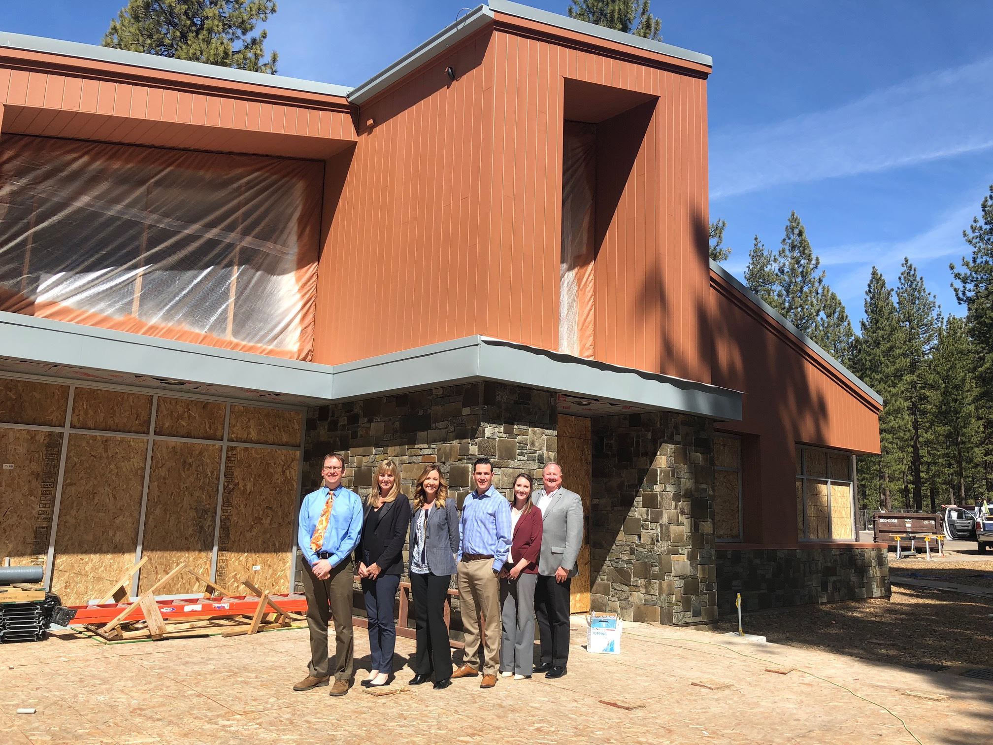 LTCC and Brandman University staff in front of the Lisa Maloff University Center on LTCC's campus