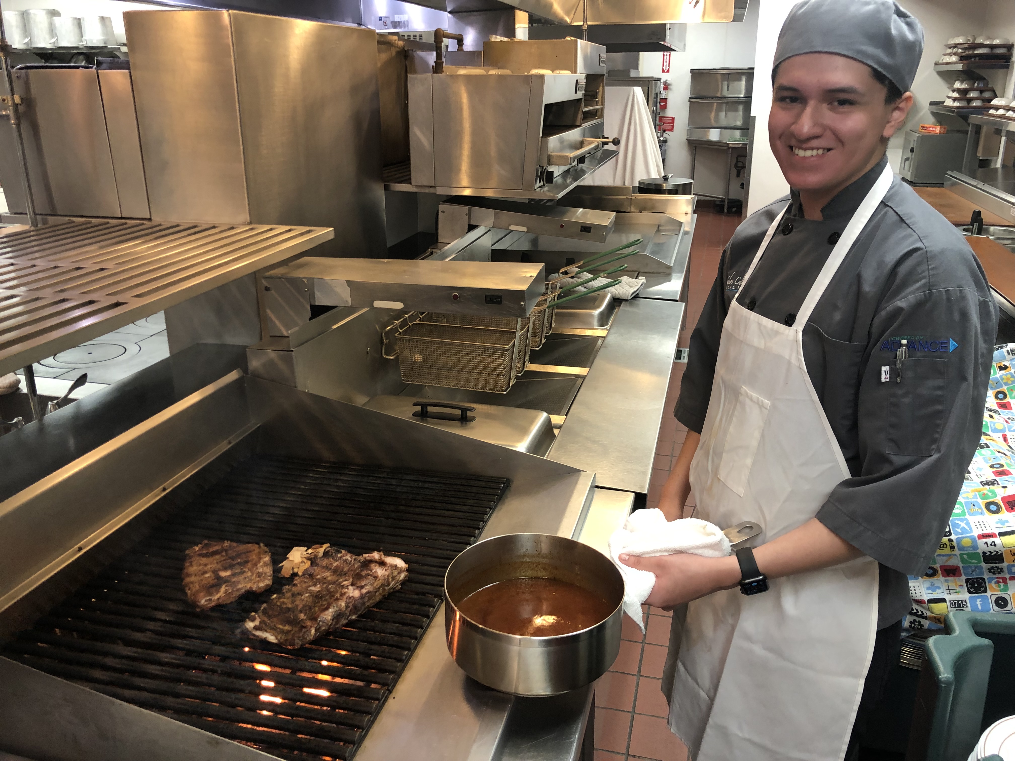 LTCC culinary arts student preparing meat