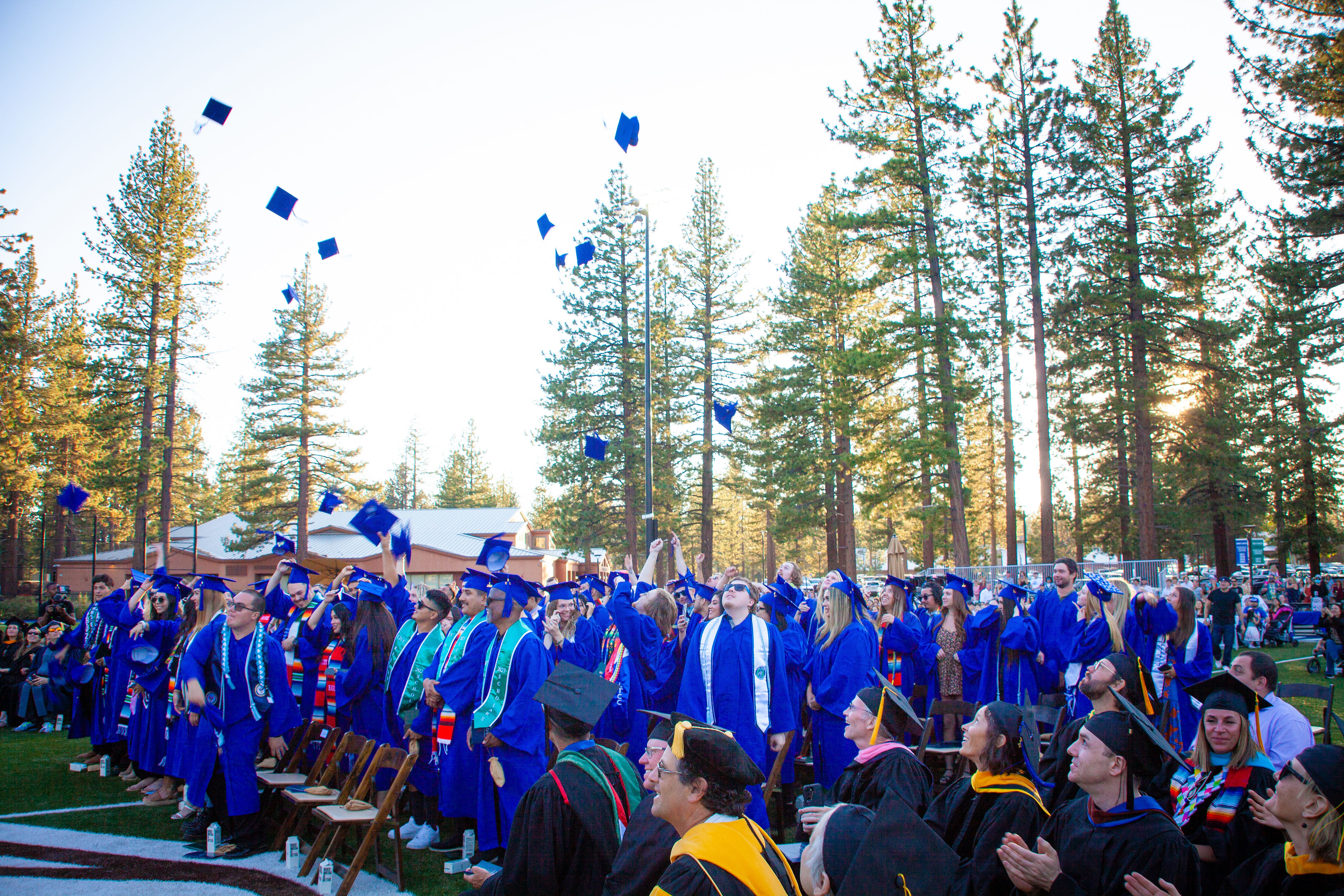 2023 graduates toss their caps ass LTCC faculty watches