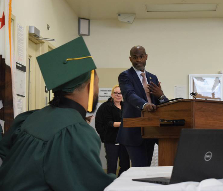 Sacramento County Chief Probation Officer Marlon Yarber speaks to the RSP graduate at his ceremony