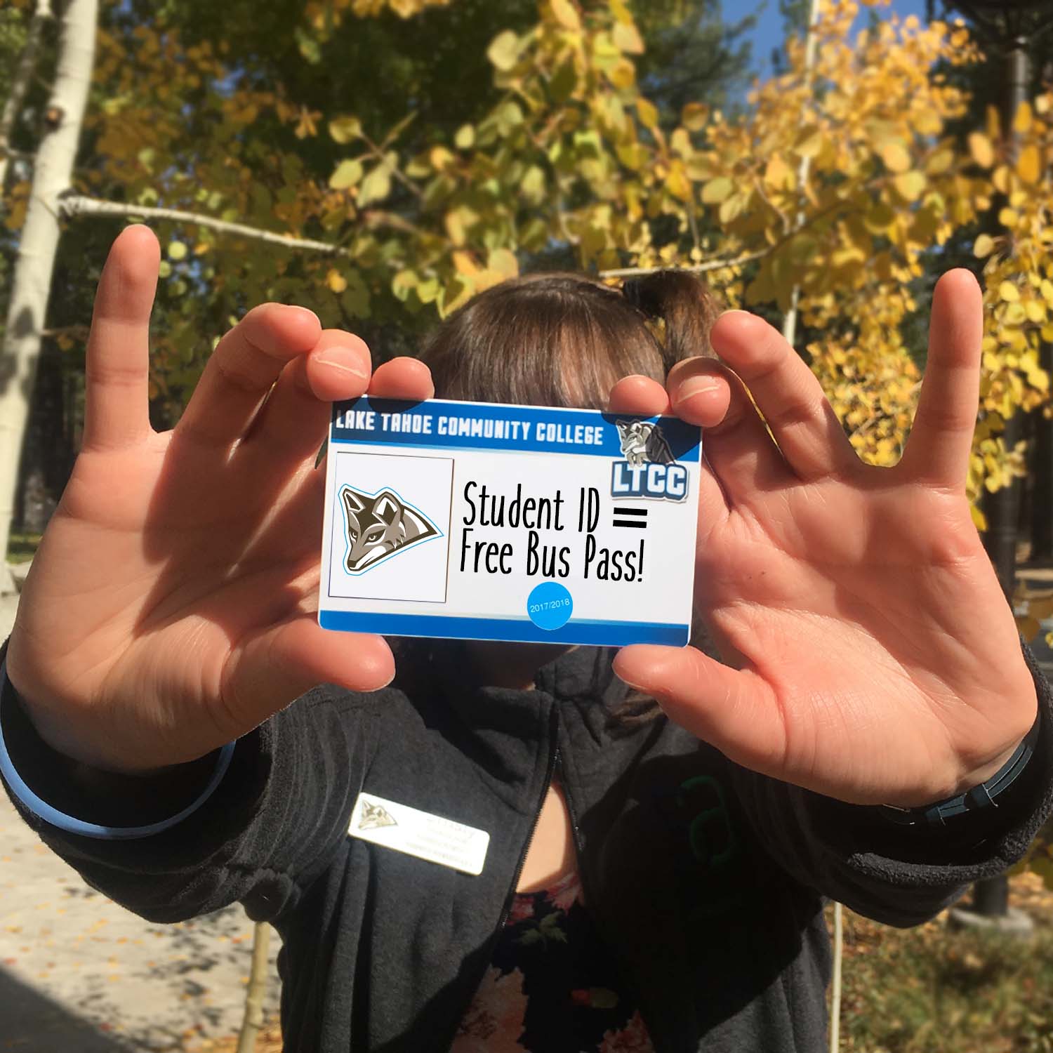 student holding up an LTCC ID card up