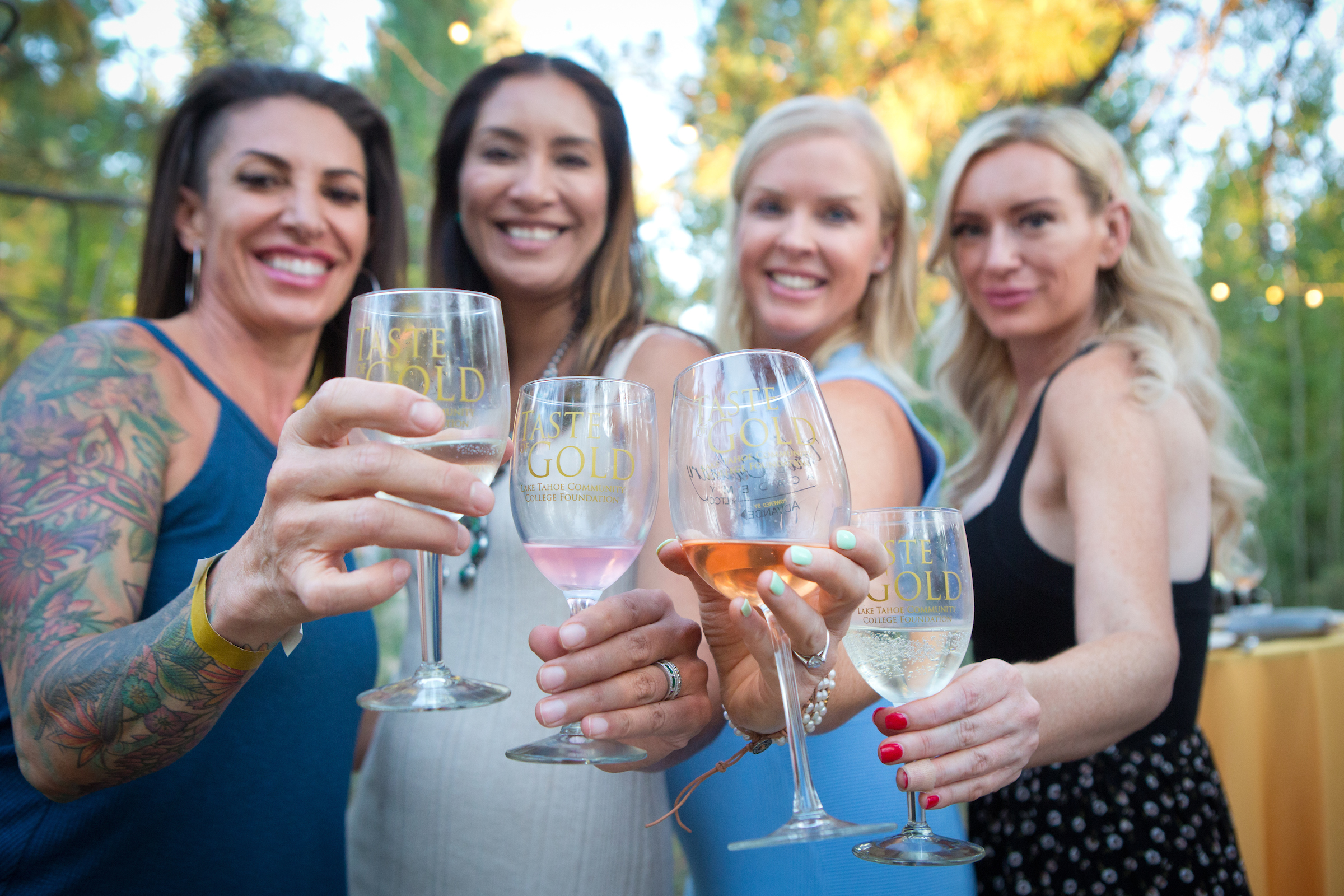 women enjoying wine tasting at Taste of Gold fundraiser